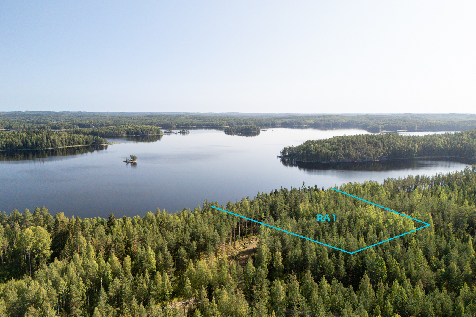 Ilmakuva tontista järven suuntaan, kuvaan on piirretty tontin rajat.